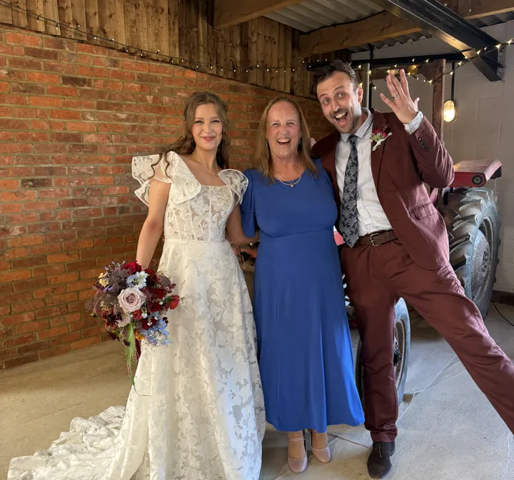 Wedding moment 1: Lesley Coles with a bride and groom in a barn venue