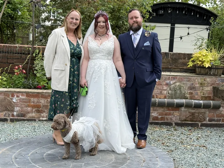 Wedding moment 4: Lesley Coles with a bride, groom and their dog